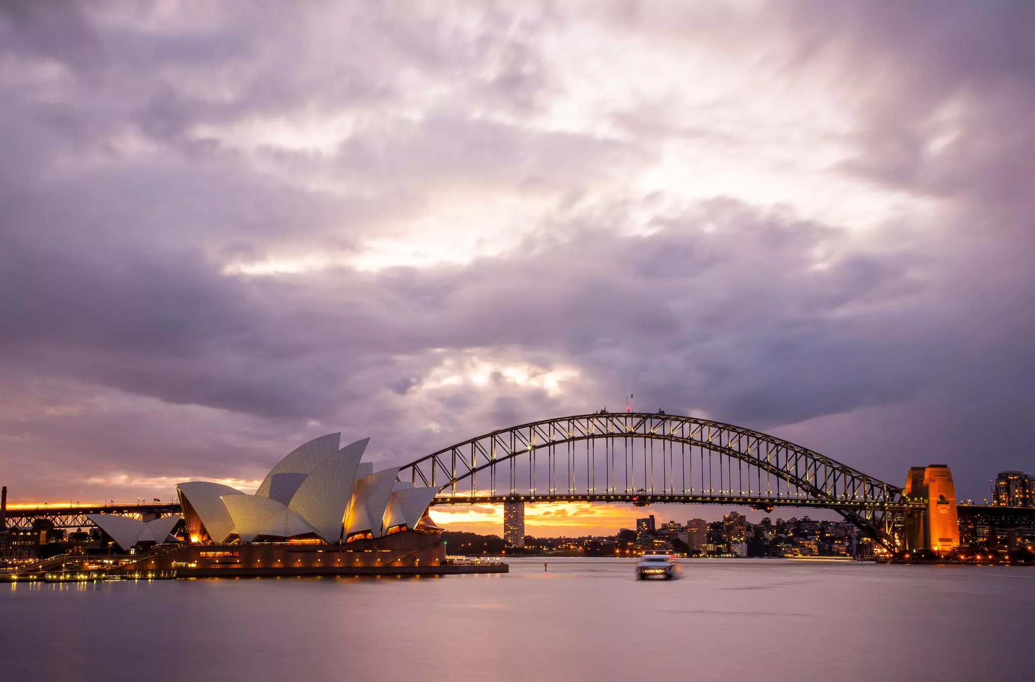 Dramatic sky and the Sydney Opera House at dusk. Sydney skyline taken from Mrs. Macquarie's Point.