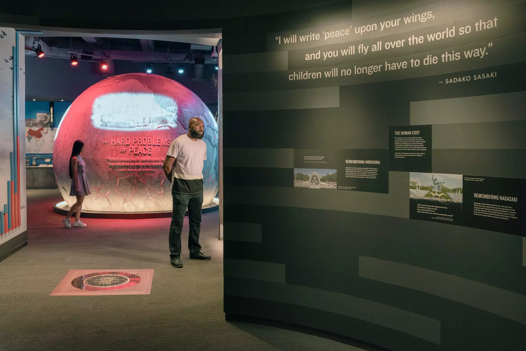 A man stops to read information on a museum display.