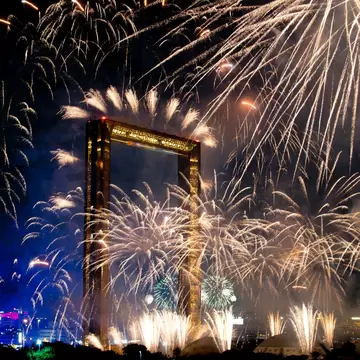 Dubai, United Arab Emirates – January 1, 2025: Fireworks light up the night sky behind the Dubai Frame as crowds celebrate New Year’s Eve in the city., License Type: media, Download Time: 2026-05-21T16:52:25.000Z, User: lonelyplanetmedia, Editorial: true, purchase_order: 65050 - Digital Destinations and Articles, job: Comp Ingestion, client: Global Publishing WIP, other: Pia Peterson