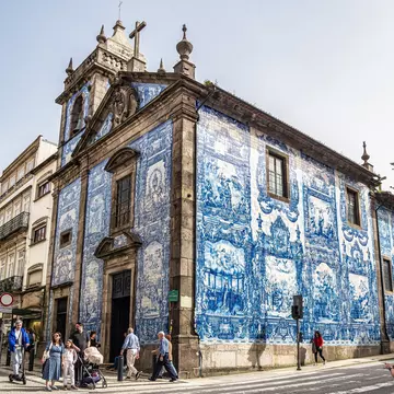 Side view from street of the famous exterior of blue and white tiles painted with scenes from the lives of saints at Chapel of Souls, Capela das Almas de Santa Catarina, Porto