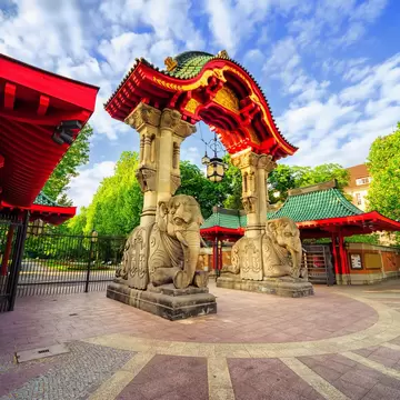 Stone elephants supporting an arched entrance to the Berlin Zoological Garden.