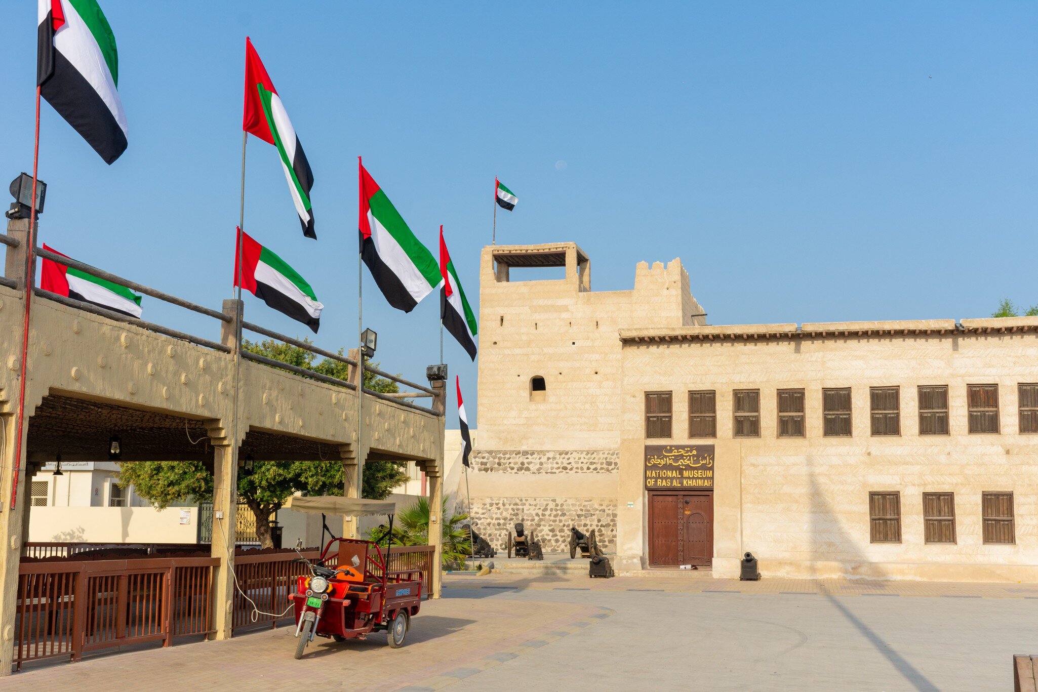 'Ras al Khaimah, RAK/United Arab Emirates - 09/28/2018 - Entrance of the Ras al Khaimah Museum in the morning sun with flags blowing.', License Type: media, Download Time: 2026-07-09T23:30:01.000Z, User: dermothegarty77, Editorial: true, purchase_order: 56530 - Guidebooks, job: Global Publishing WIP, client: Oman, UAE & Arabian Peninsula, other: Dermot Hegarty