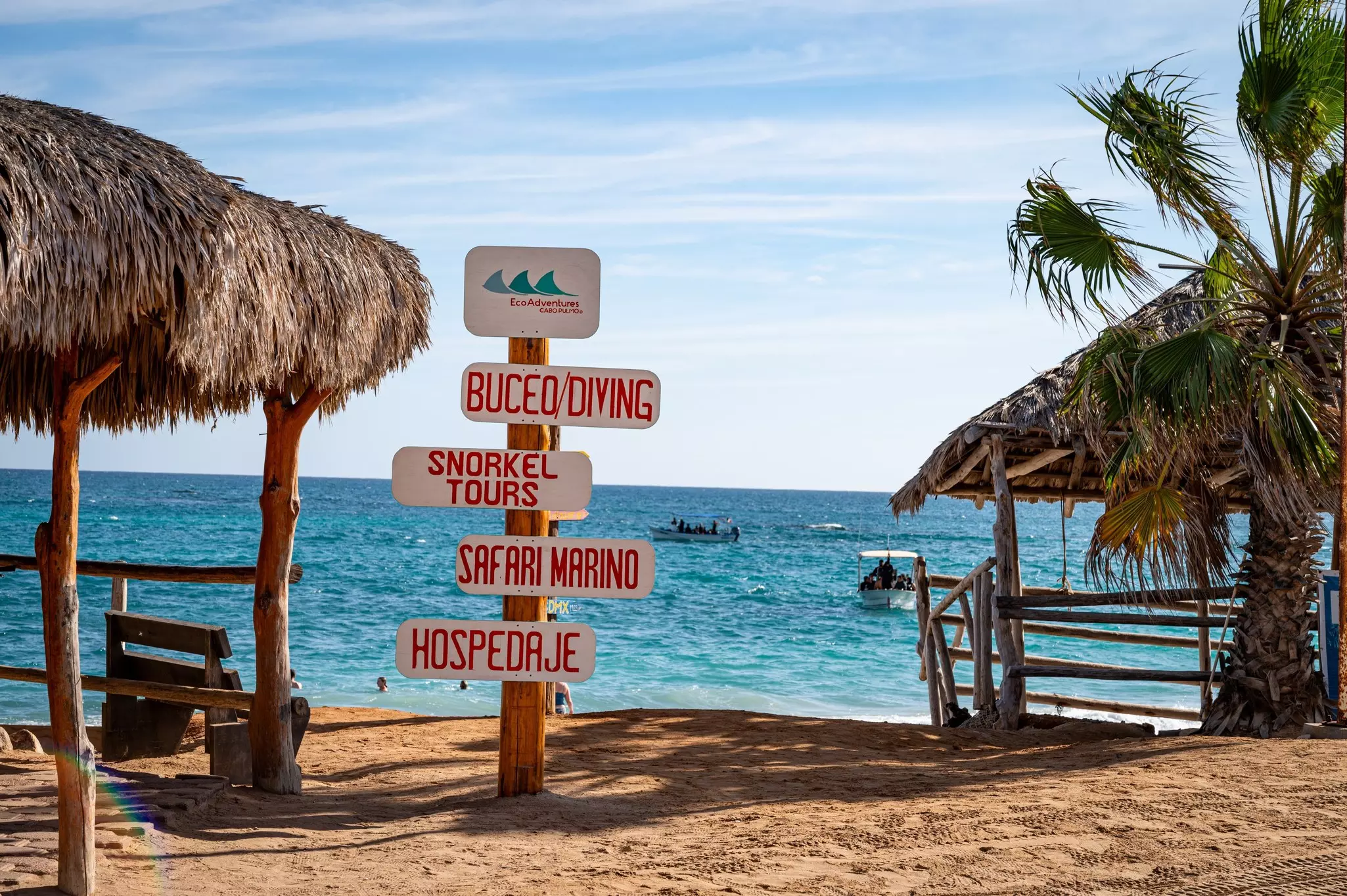 A variety of mostly tongue-in-check directional signs next to beach structures at Cabo Pulmo, a protected National Marine Park recognized as an UNESCO site.