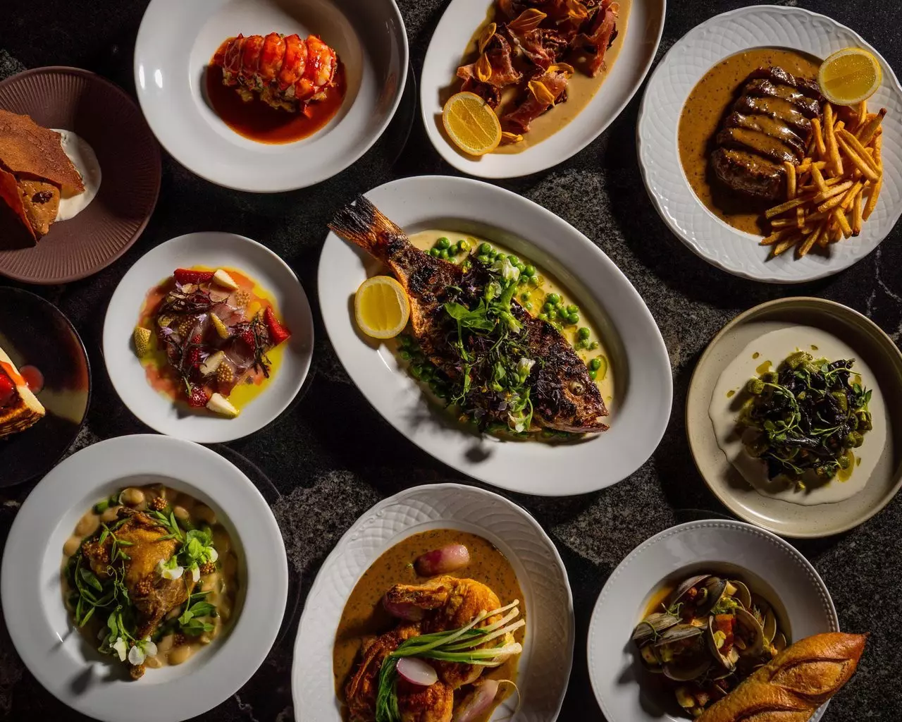 Plates of food from Le Coq in La Jolla, San Diego.