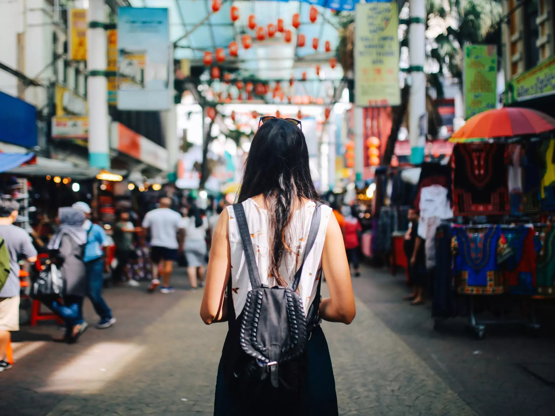 Young traveler woman walking through the stalls in Chinatown district of Kuala Lumpur, Malaysia