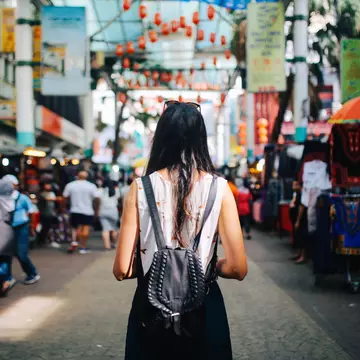 Young traveler woman walking through the stalls in Chinatown district of Kuala Lumpur, Malaysia