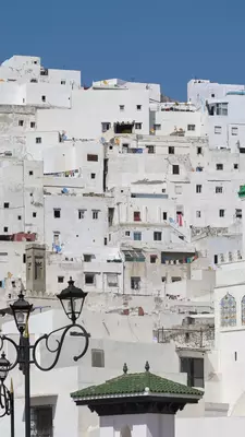 A cityscape of white buildings in a Moroccan town. 
