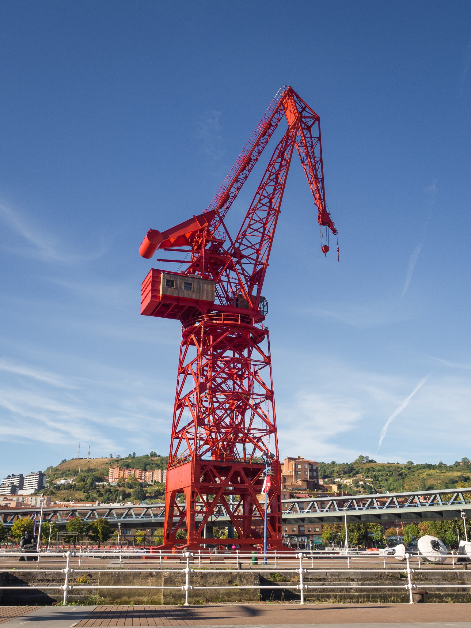 View of a crane called 'Carola' in the old shipyards next to the river on a sunny day in Bilbao, Spain.