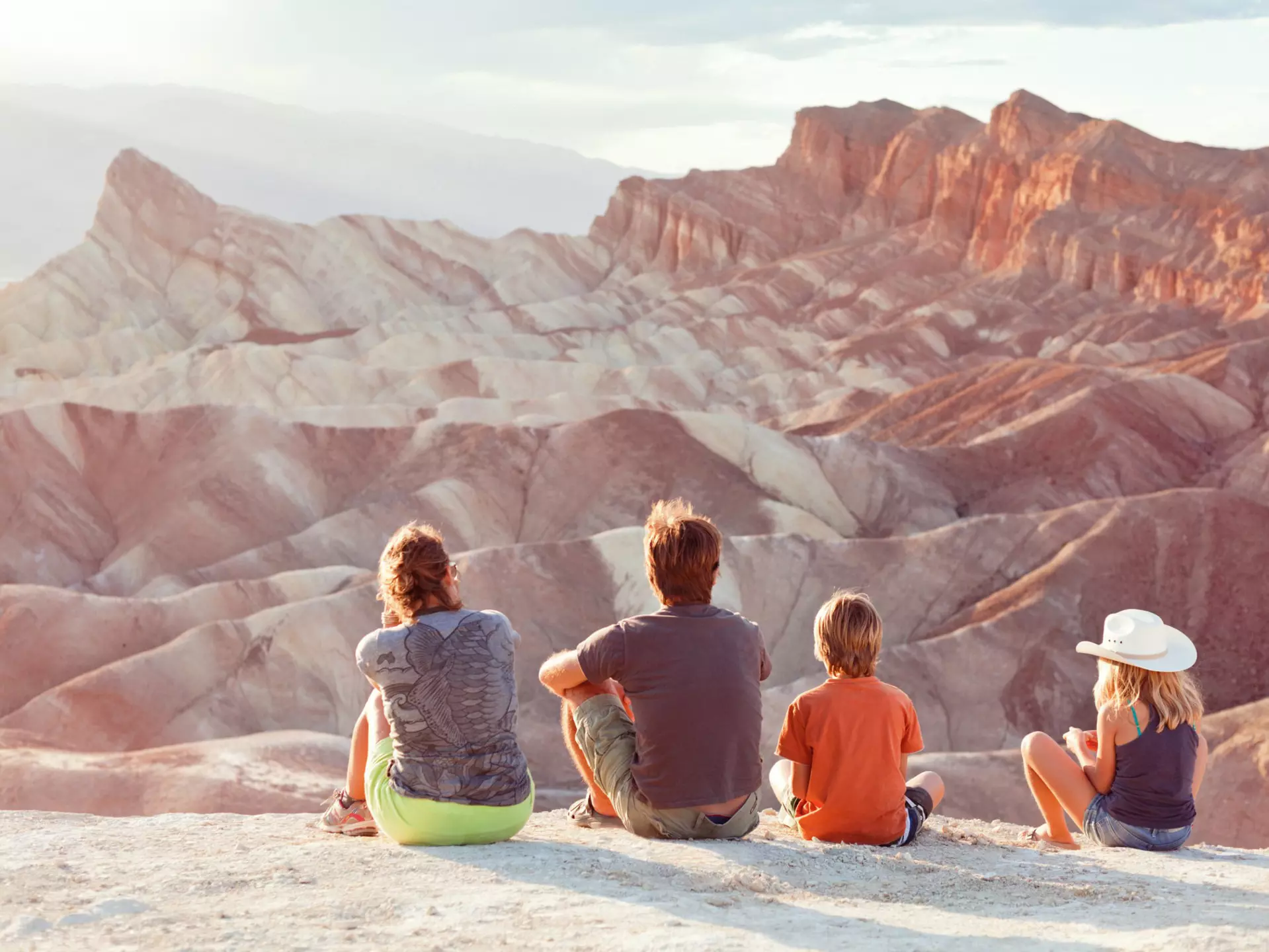 Family watching the sunset at Zabriskie Point in Death Valley. Armin Adams / Getty Images