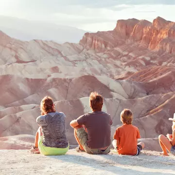 Family watching the sunset at Zabriskie Point in Death Valley. Armin Adams / Getty Images
