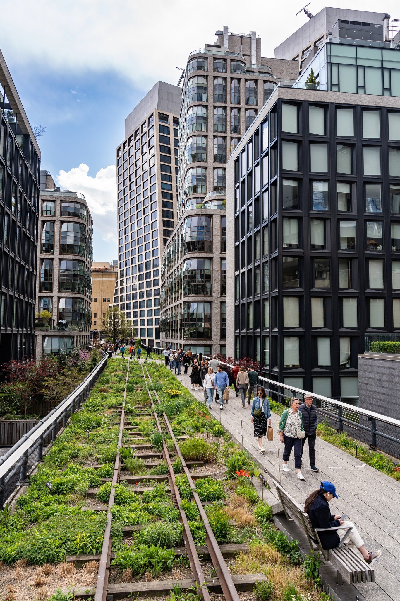 Crowds of people walking along the High Line, NYC.