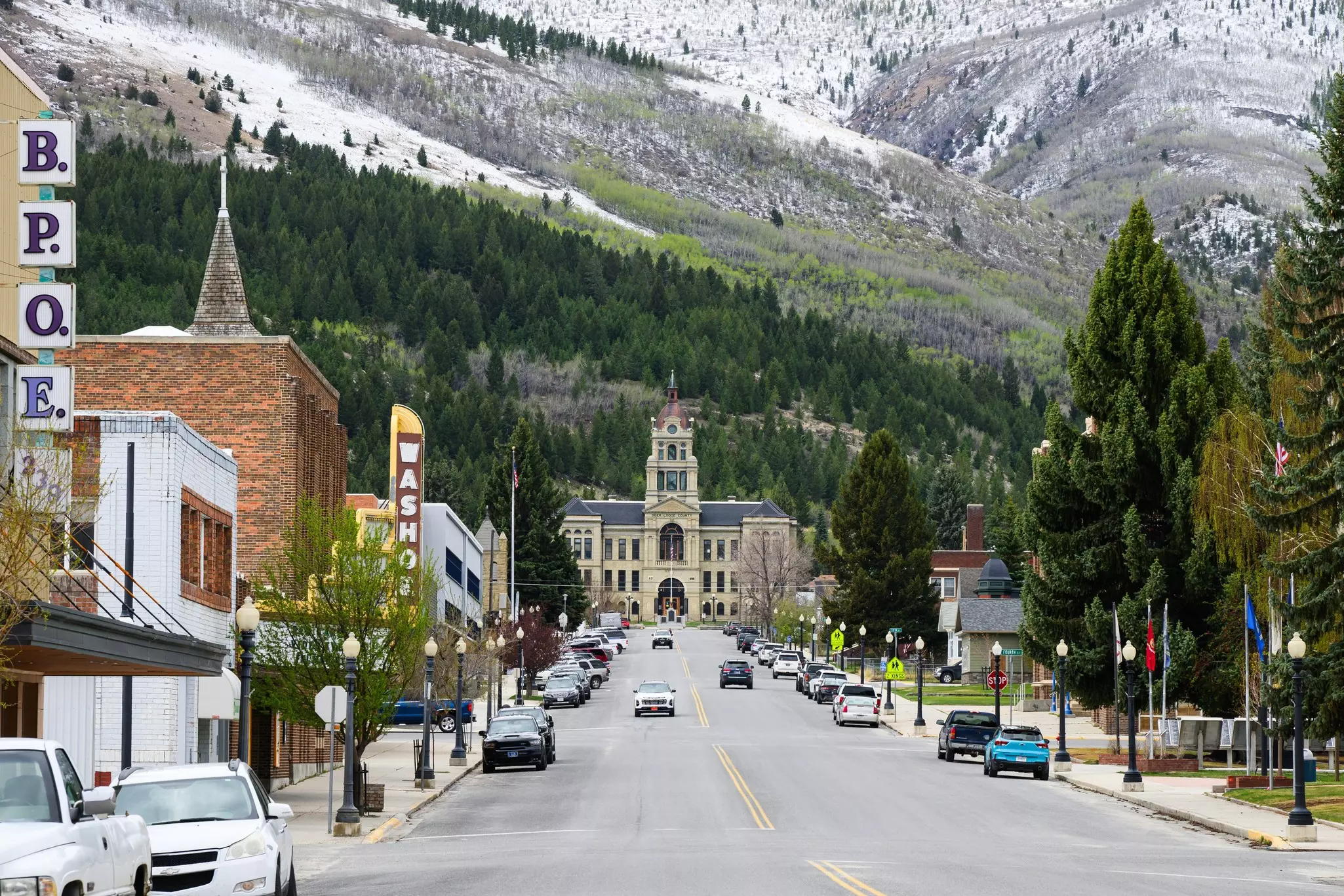 A view along the main street in Anaconda, Montana, with mountain slopes rising behind the buildings.