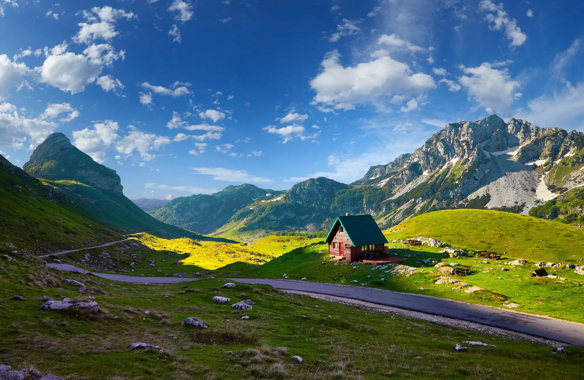 A small chalet in a mountain region on a sunny day