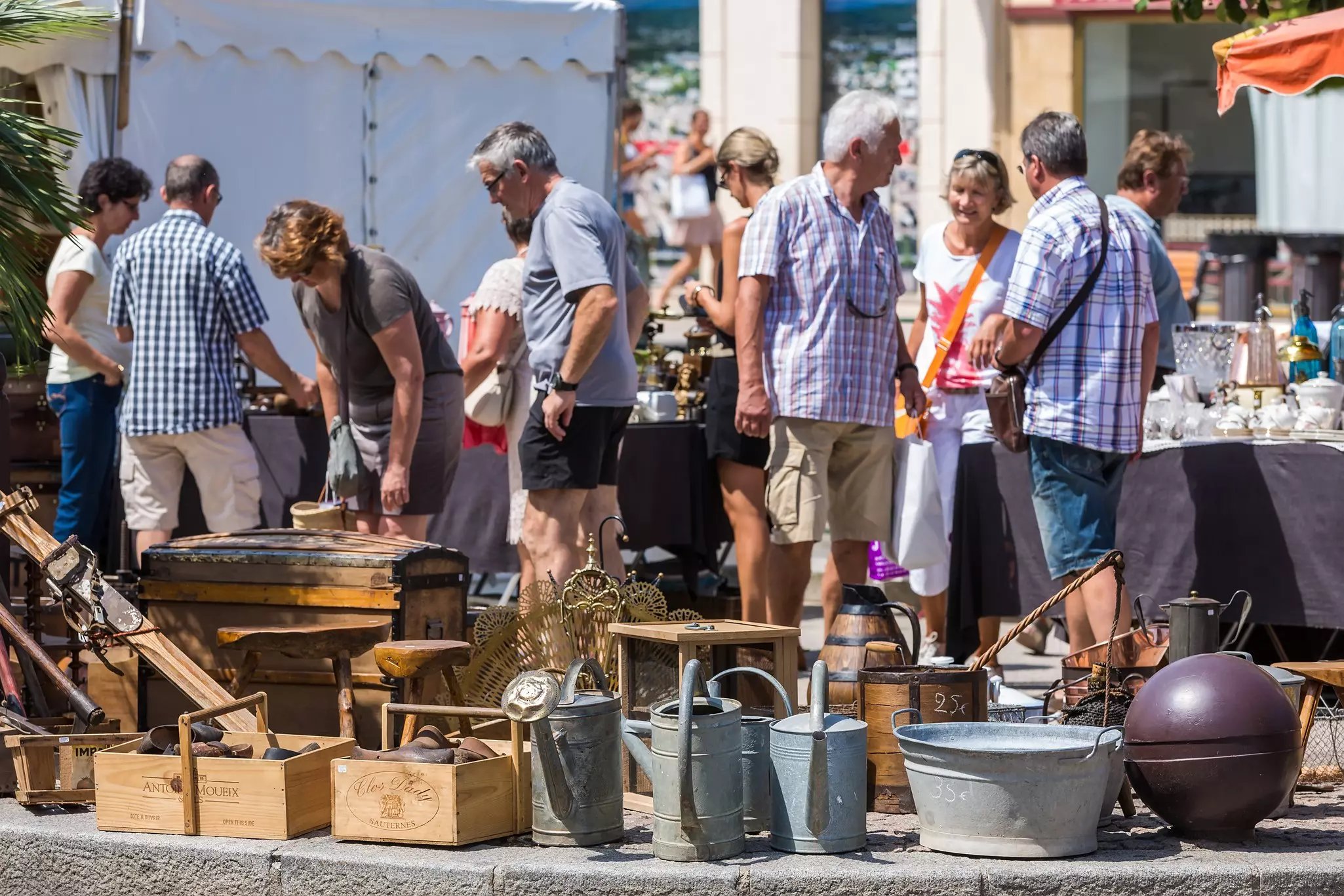 People shopping at an outdoor flea market.
