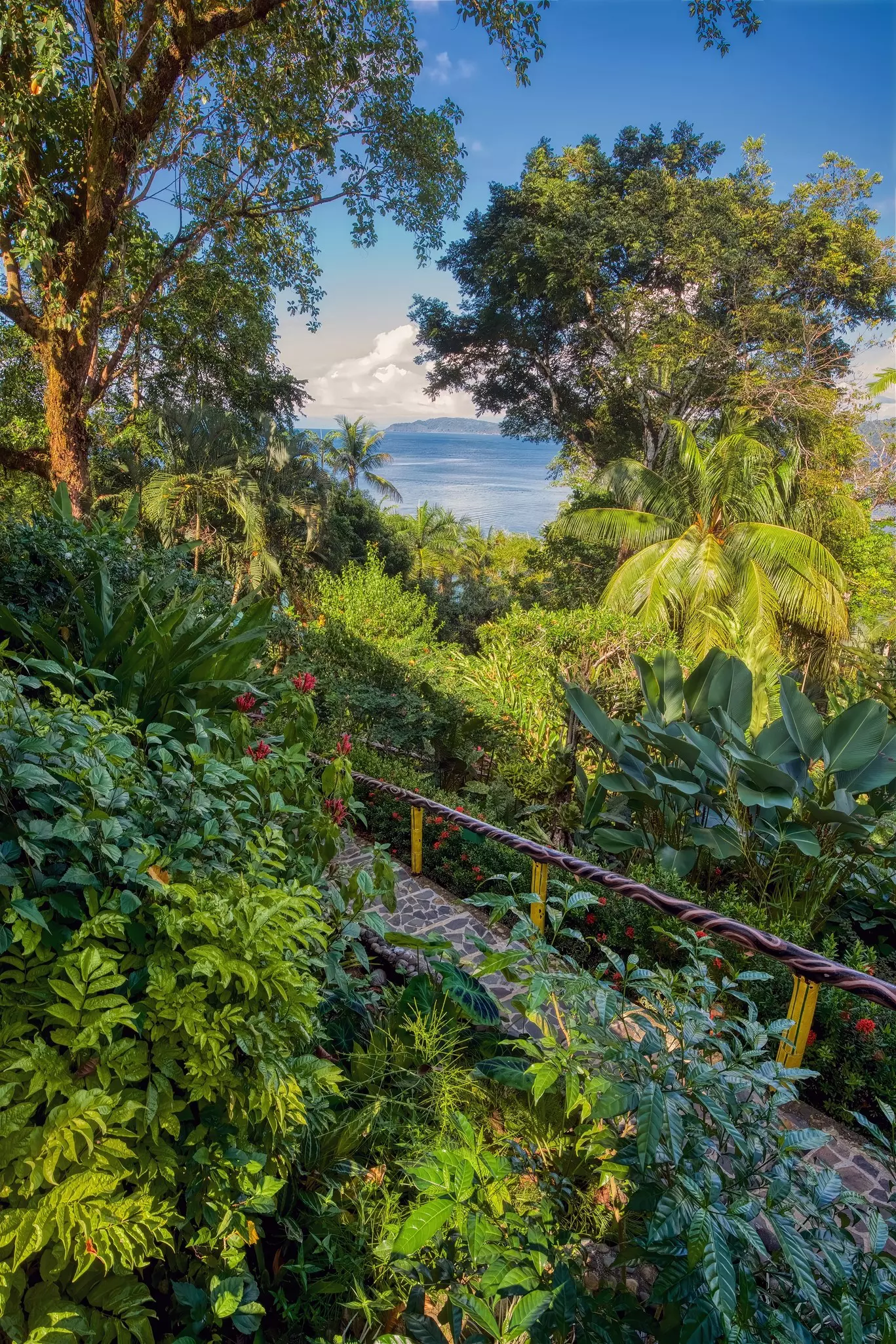 Lush garden with body of water in background