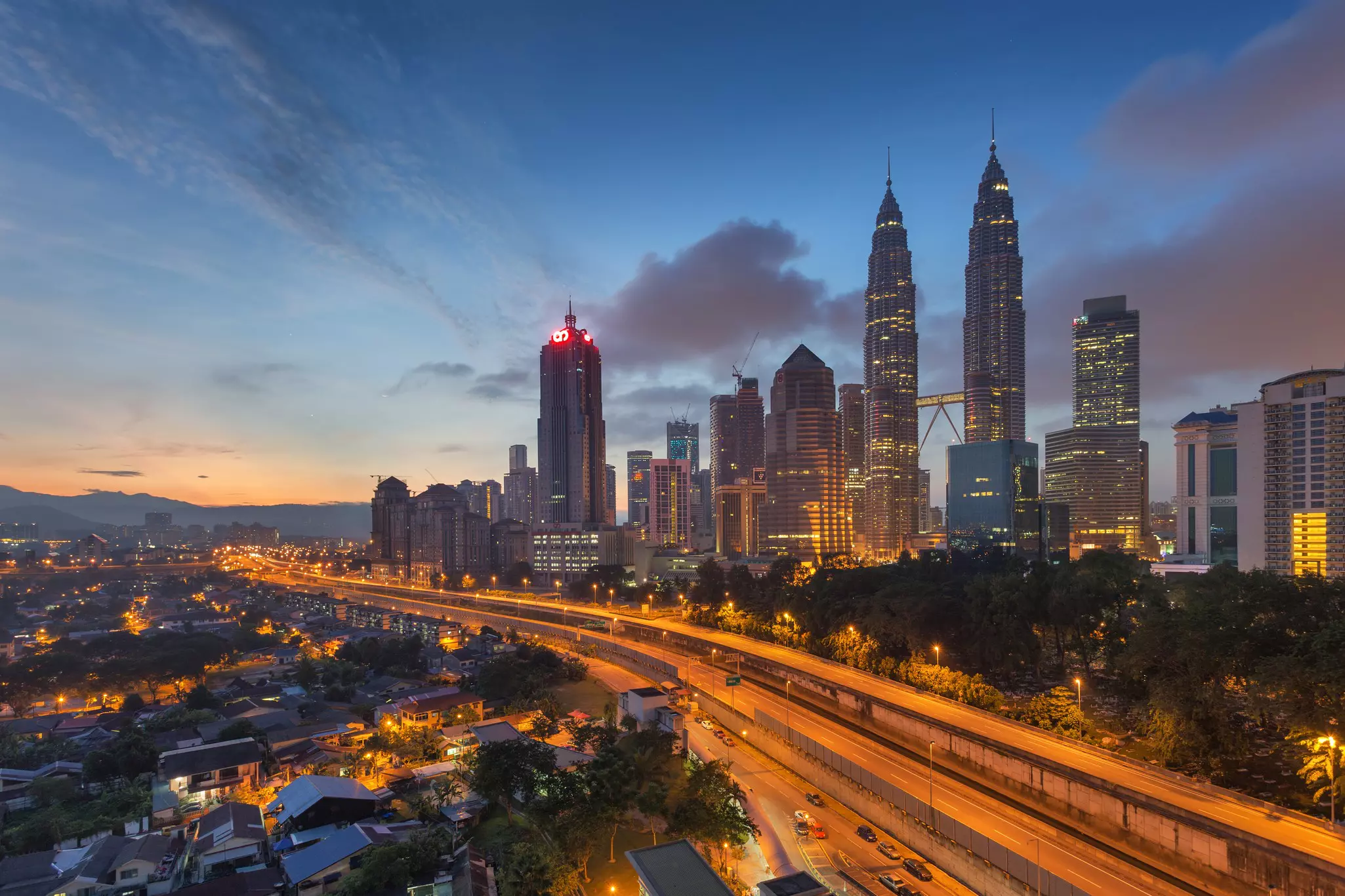 The skyline of Kuala Lumpur with the Petronas Towers, seen from Kampung Baru in the early morning, Malaysia.