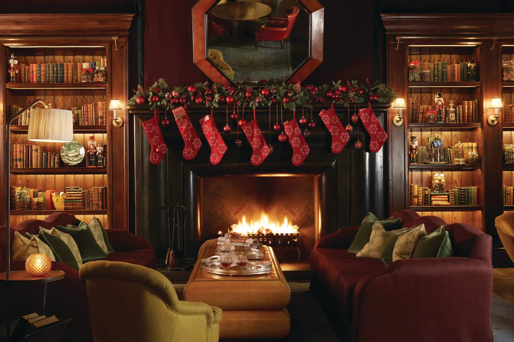The fireplace at Scarfes Bar at Rosewood Holborn is decked out with stockings for the holidays.