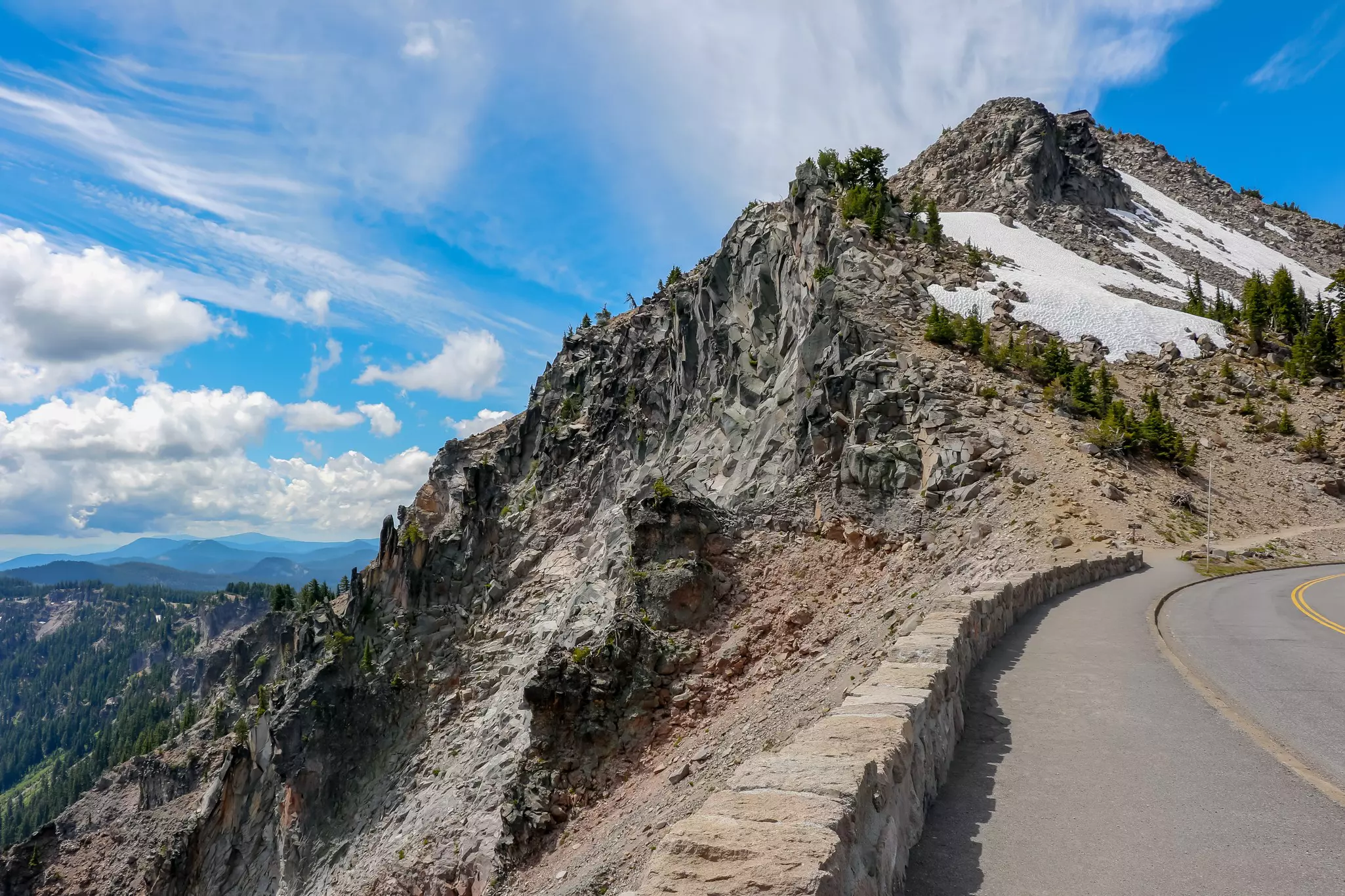 Road around of Crater Lake National Park with Snow on Mountain and Blue Sky in Summer at Oregon, USA,