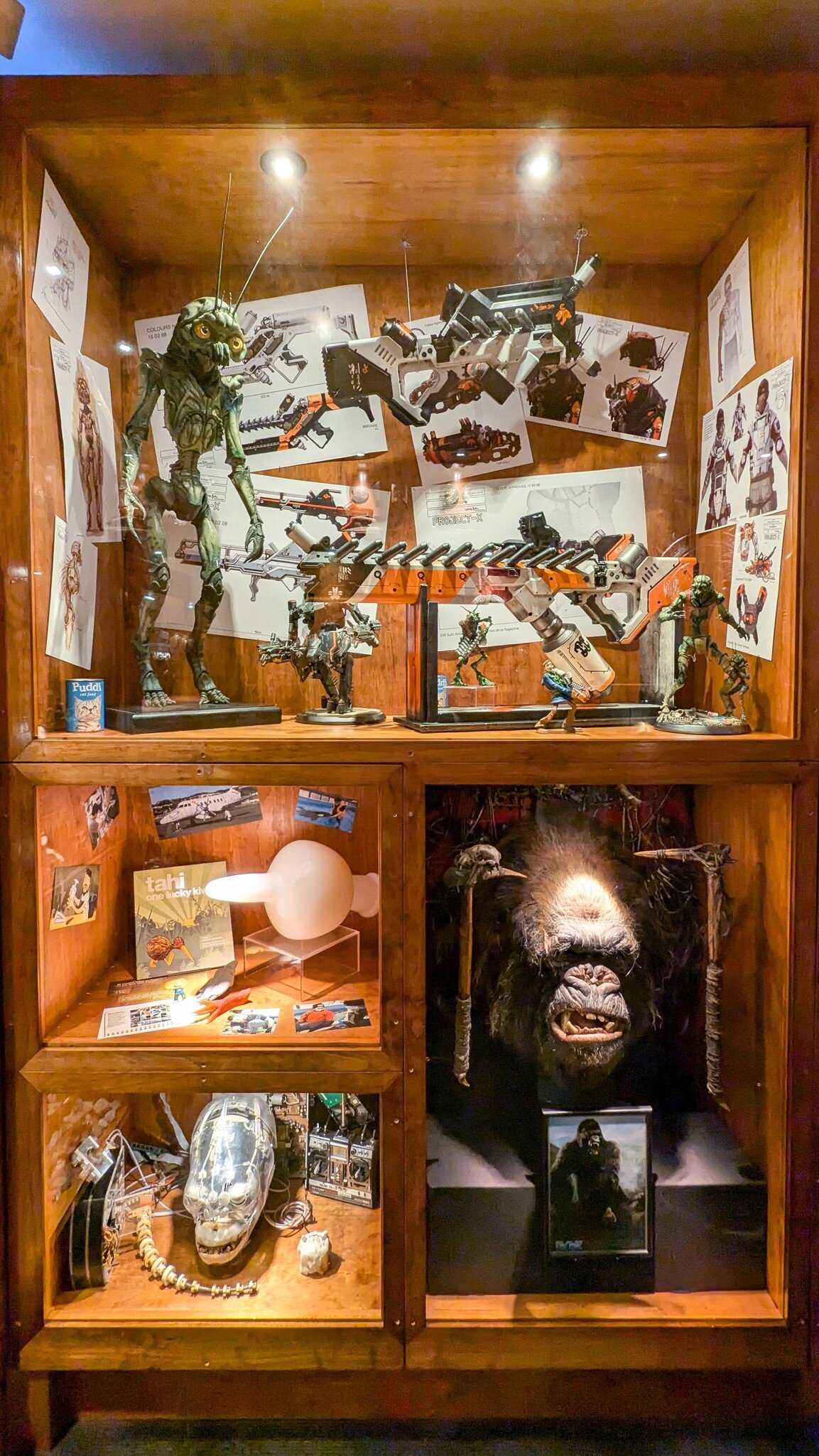 Cabinets of film artefacts inside Weta Cave shop (Wētā Workshop) and museum in Miramar, capital city of NZ Aotearoa. Wellington, New Zealand.