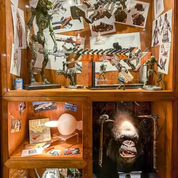 Cabinets of film artefacts inside Weta Cave shop (Wētā Workshop) and museum in Miramar, capital city of NZ Aotearoa. Wellington, New Zealand.