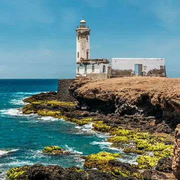 The Farol de Dona Maria Pia lighthouse at low tide in Praia, Cape Verde