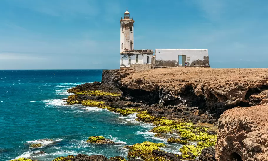 The Farol de Dona Maria Pia lighthouse at low tide in Praia, Cape Verde