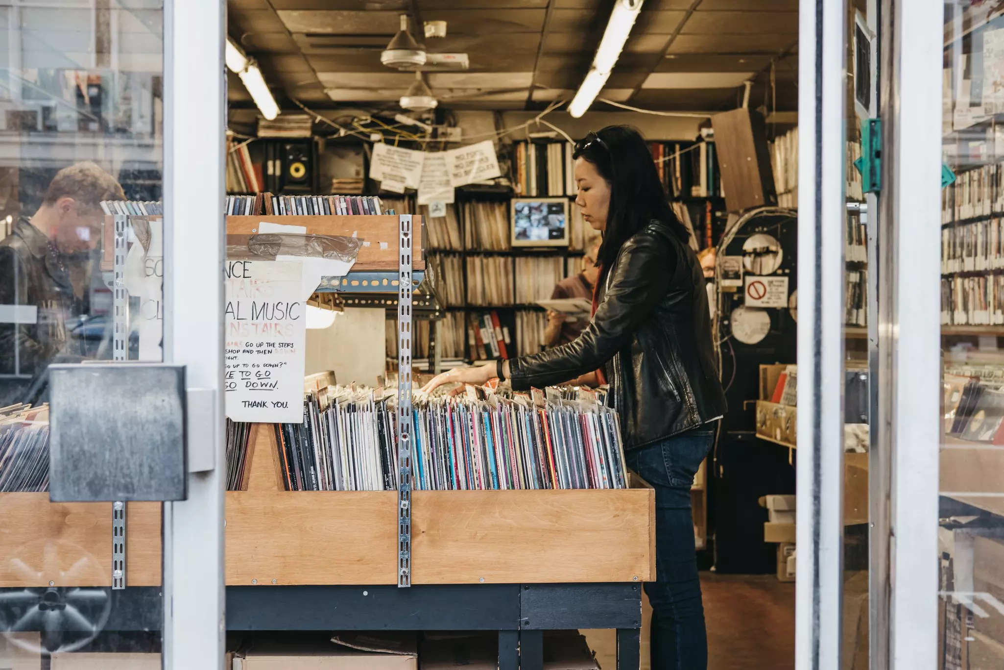 A woman browsing vinyl records at a store in Notting Hill, London.