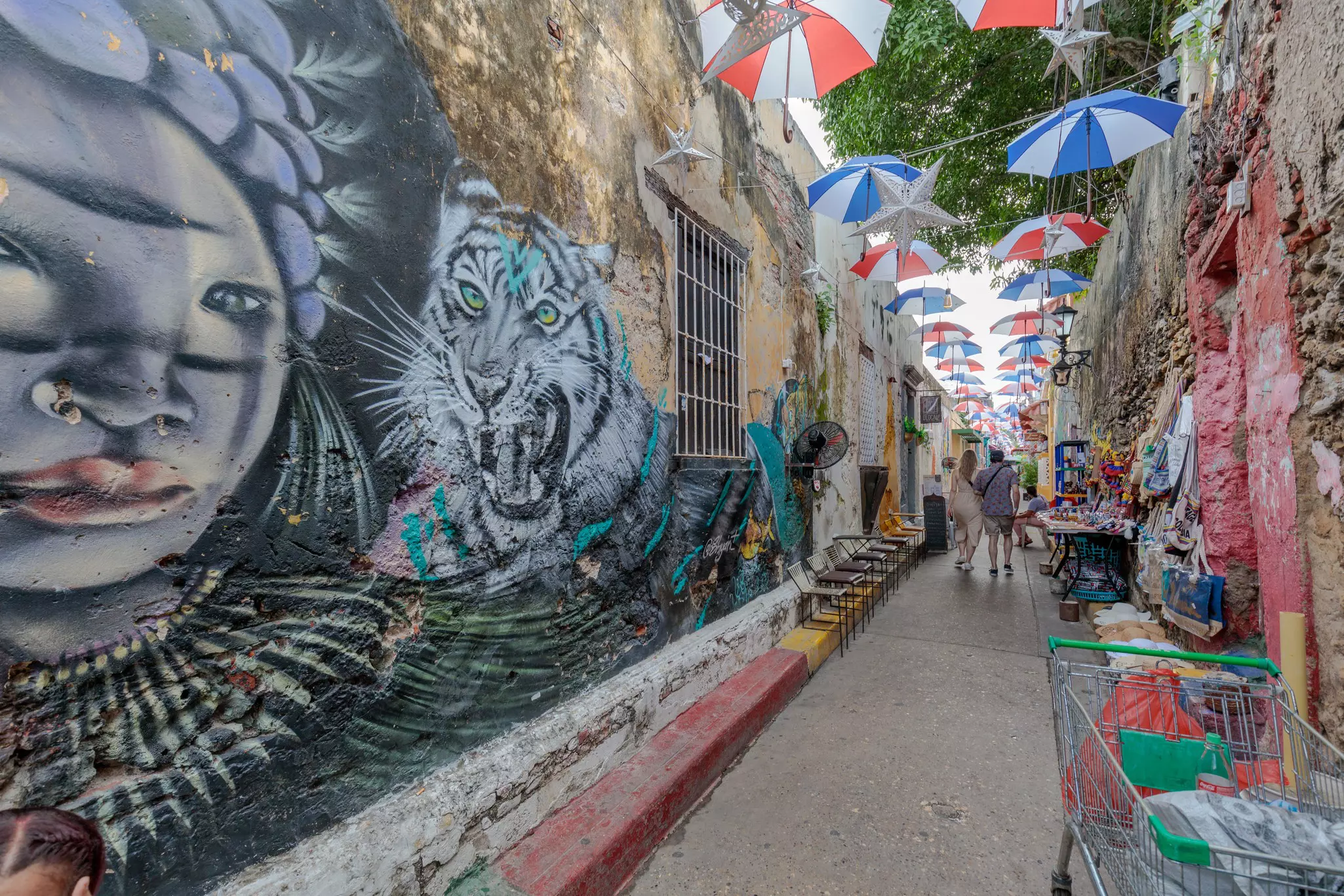 Street art murals of faces on a white wall