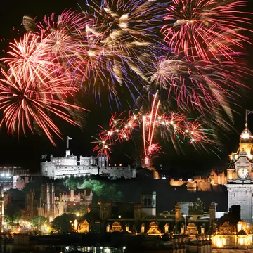 Fireworks over Edinburgh's city center for Hogmanay (New Year’s Eve) during the Edinburgh Festival and Edinburgh Military Tattoo.