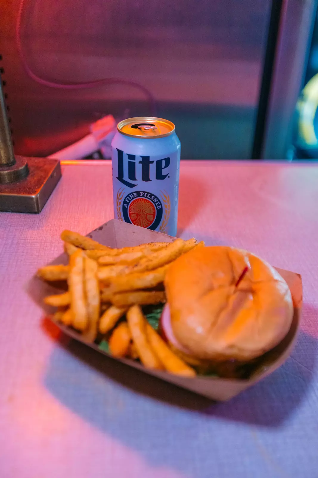 A cheeseburger, fries, and Miller Lite beer can