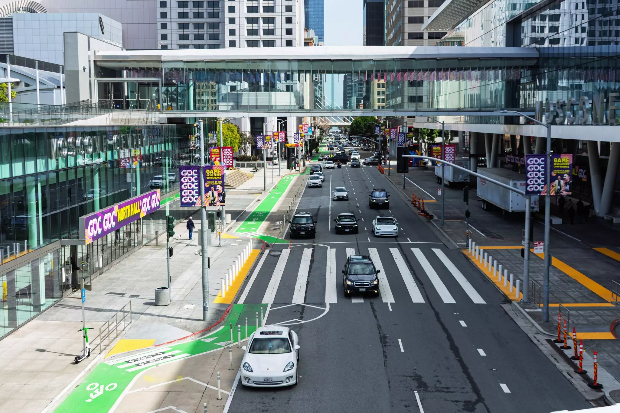 Overhead view of city street with green-painted bike lanes.