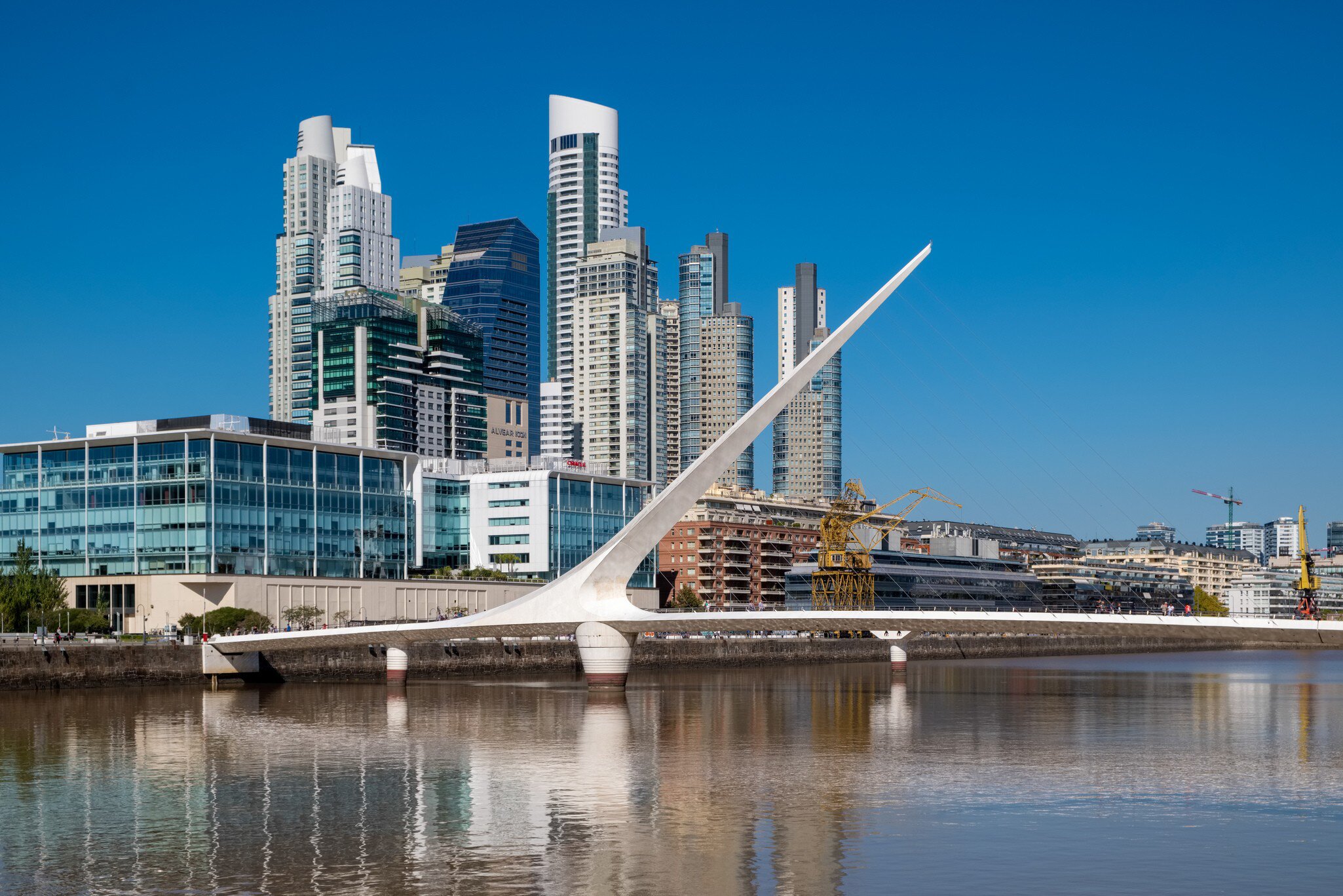 The Waterfront (Puerto Madero) with the Puente de la Mujer suspension bridge in Buenos Aires, Argentina, South America.
1187356187
Cantilever Spar Cable-Stayed Bridge, Photography, Business, Pano, Panoramic, City Life, Water, Argentina, Bright, Sky, Sunny, Outdoors, City, River, Travel, Skyscraper, Waterfront, Modern, Reflection, Puente de la mujer, No People, Famous Place, Harbor, Urban Skyline, Business Finance and Industry, Capital Cities, Building Exterior, Suspension Bridge, Downtown District, Travel Destinations, Horizontal, Cityscape, Architecture, Bridge - Built Structure