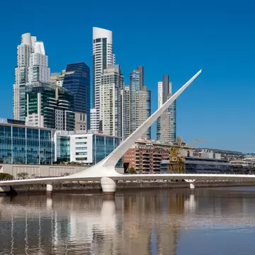 The Waterfront (Puerto Madero) with the Puente de la Mujer suspension bridge in Buenos Aires, Argentina, South America.
1187356187
Cantilever Spar Cable-Stayed Bridge, Photography, Business, Pano, Panoramic, City Life, Water, Argentina, Bright, Sky, Sunny, Outdoors, City, River, Travel, Skyscraper, Waterfront, Modern, Reflection, Puente de la mujer, No People, Famous Place, Harbor, Urban Skyline, Business Finance and Industry, Capital Cities, Building Exterior, Suspension Bridge, Downtown District, Travel Destinations, Horizontal, Cityscape, Architecture, Bridge - Built Structure
