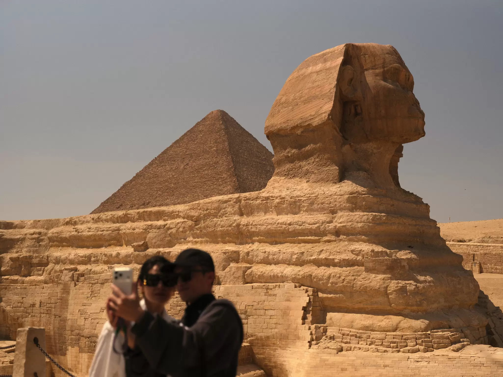 A couple snaps a selfie in front of the Great Sphinx of Giza in Egypt.