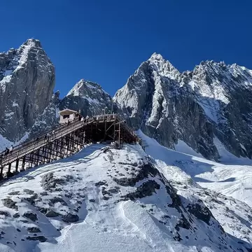 Image of stunning peaks and a walking trail on the Jade Dragon Snow Mountain, also known as Yulong Snow Mountain, near Lijiang in Yunnan, China. , License Type: media, Download Time: 2026-09-02T17:22:06.000Z, User: LP_NZhan, Editorial: false, purchase_order: 65050 - Digital Destinations and Articles, job: App Content, client: Lonely Planet App, other: Nadine Zhan 