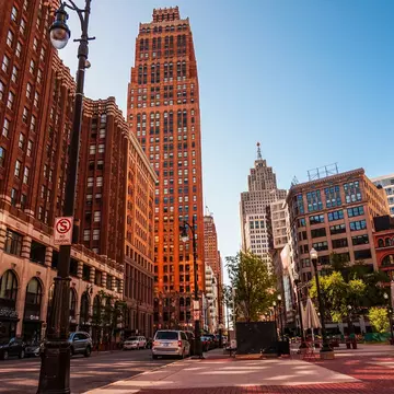 Tall buildings lining a street in downtown Detroit. nvphoto/Getty Images