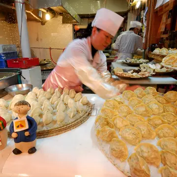 Woman making mandu (dumplings) in Seoul, South Korea