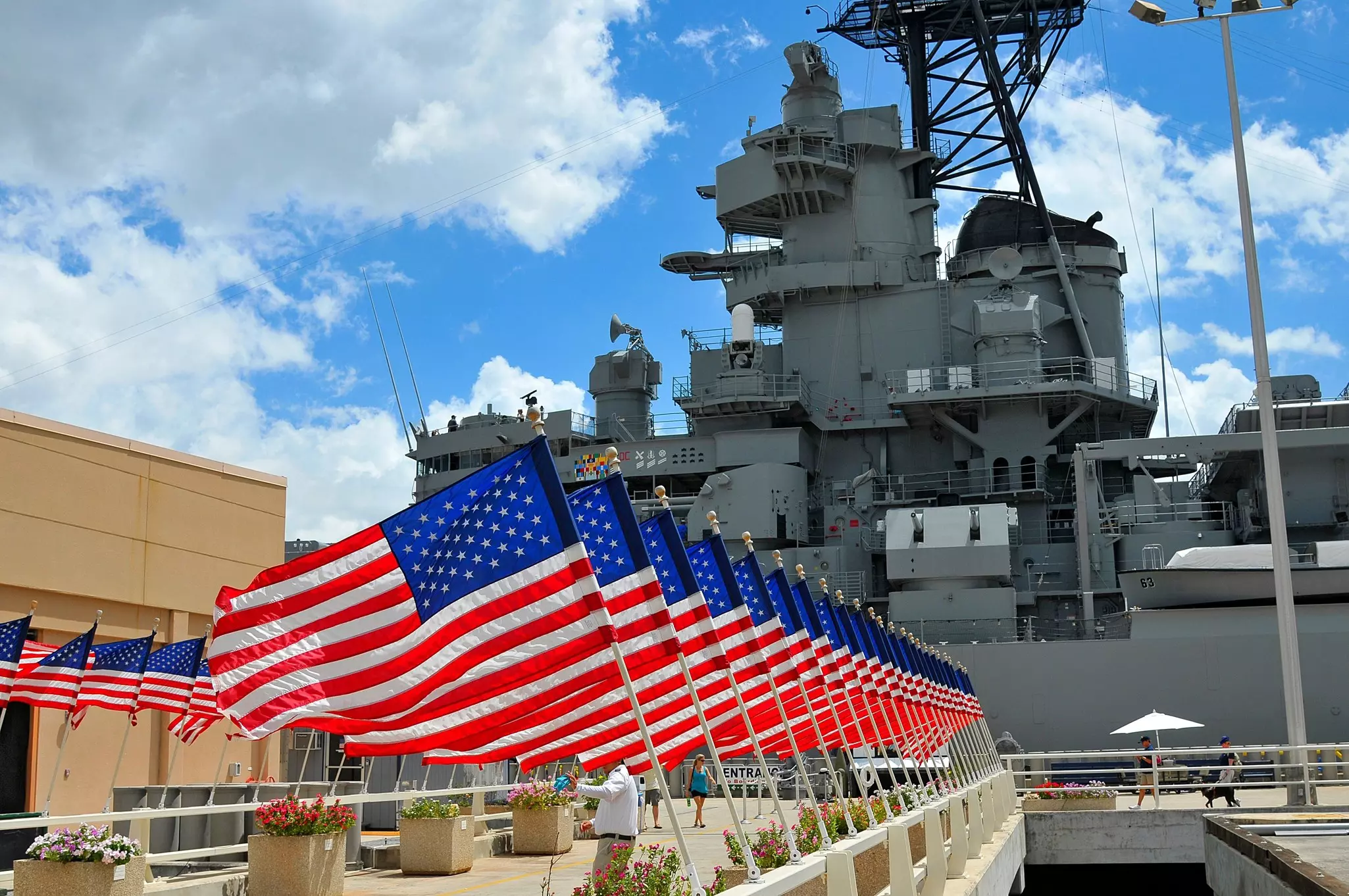 A row of flags is displayed at a military memorial