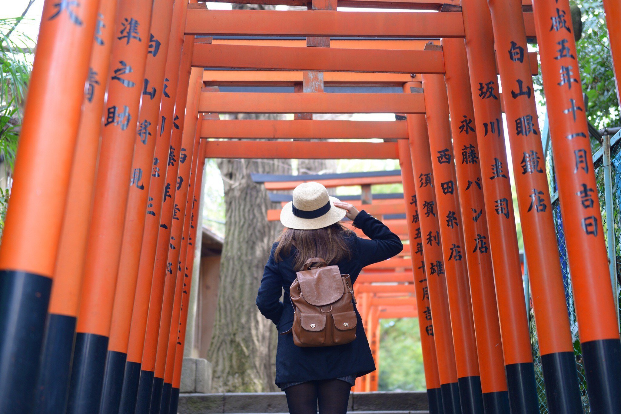 10-February-2017 Tokyo, Japan: Woman tourist is walking and sightseeing inside the Vermilion Torii Gates In Hanazono Inari Shrine, Ueno Park in Tokyo, Japan.; Shutterstock ID 692641990; your: Ben N Buckner; gl: 65050; netsuite: Online Editorial; full: Tokyo Walking