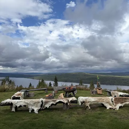 The view from Finnskogtoppen, with water, trees and a cloudy sky