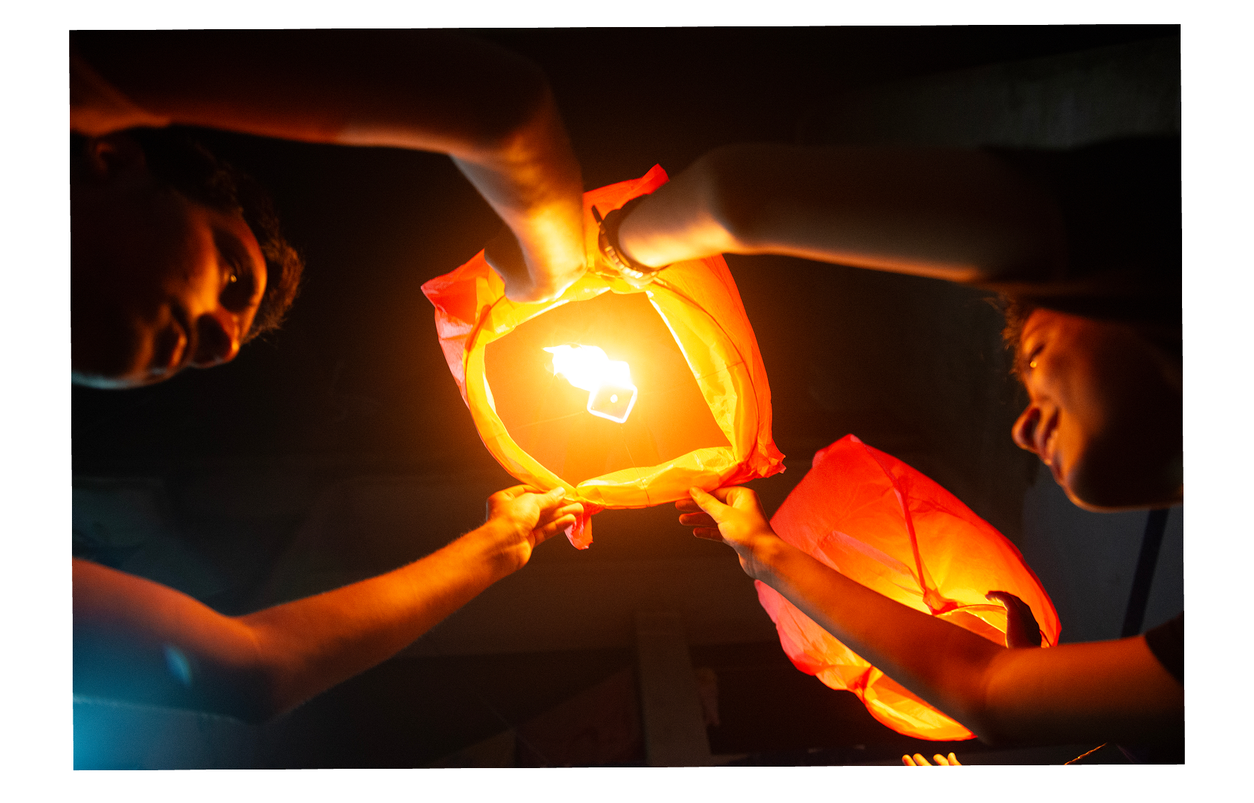 Two people holding a lantern