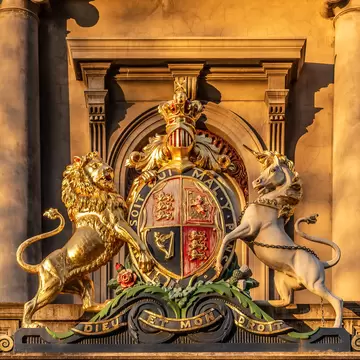 A Coat of Arms in the late afternoon golden hour sunlight on the old Royal Mint Building, now the Hellenic Museum in Melbourne, Australia.