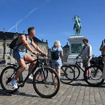 Copenhagen, Denmark - August 1, 2024: A cyclists near the Amalienborg Palace in Copenhagen., License Type: media, Download Time: 2025-02-13T11:21:38.000Z, User: claramonitto, Editorial: true, purchase_order: 56530 - Guidebooks, job: Global Publishing-WIP, client: Pocket Copenhagen 7, other: Clara Monitto