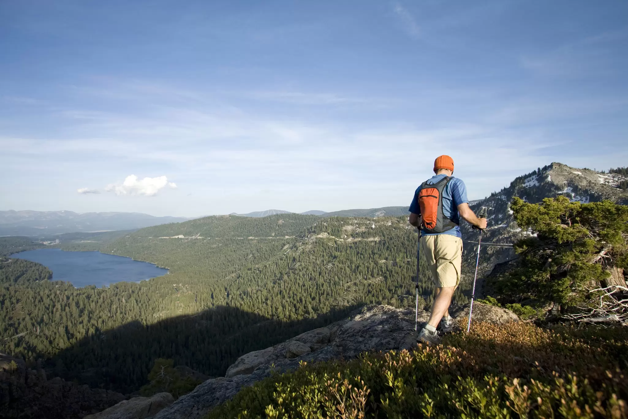 A hiker traverses a trail above Donner Lake near Lake Tahoe, California.