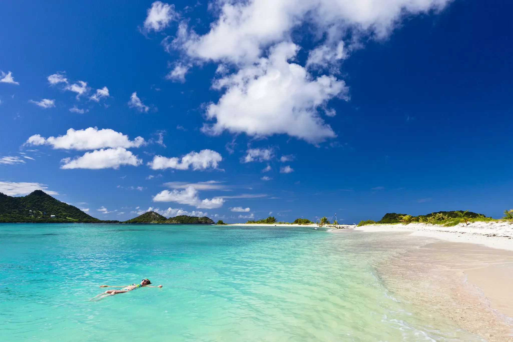 Woman floating on the turquoise waters of Martinique. ©Flavio Vallenari/Getty Images