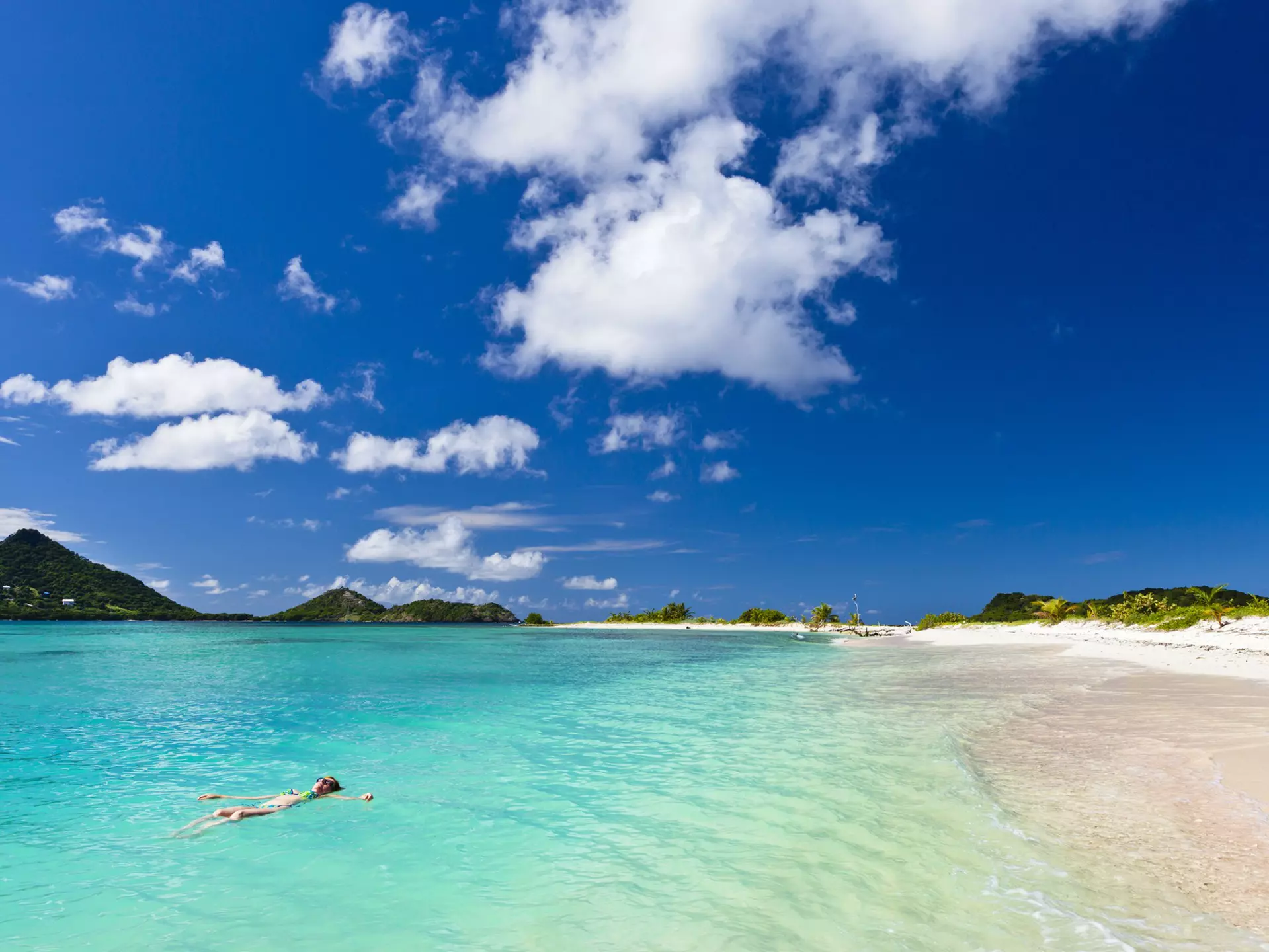 Woman floating on the turquoise waters of Martinique. ©Flavio Vallenari/Getty Images