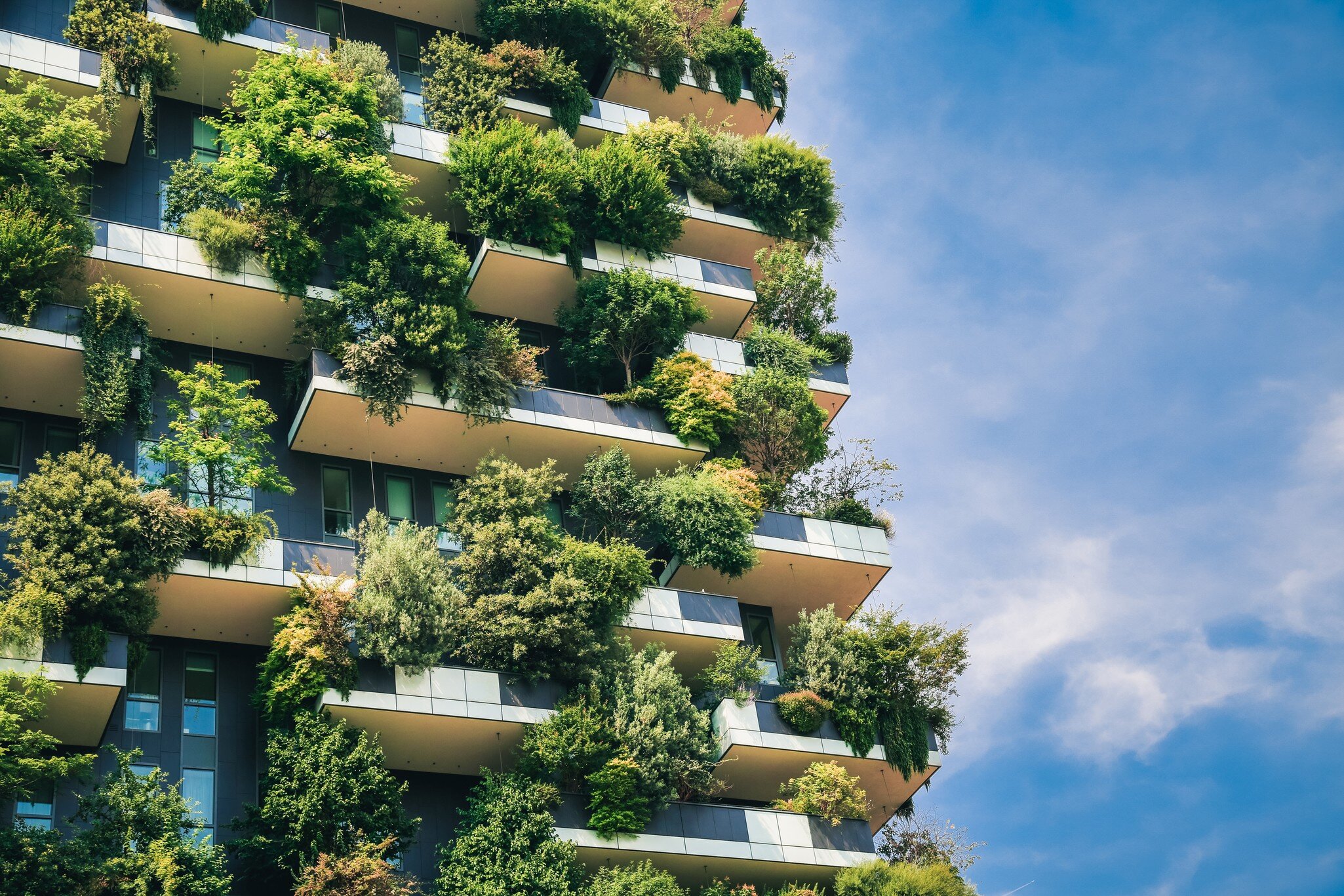 Green futuristic skyscraper Bosco Verticale, vertical forest apartment building with gardens on balconies. Modern sustainable architecture in Porta Nuova district,  Milan, Italy.