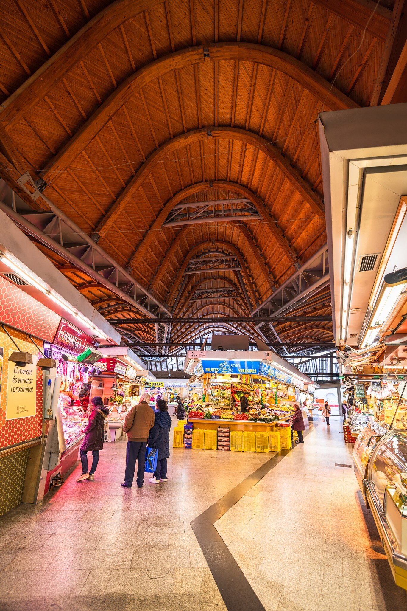 People shopping inside the Mercat de Santa Caterina in Barcelona, Spain.