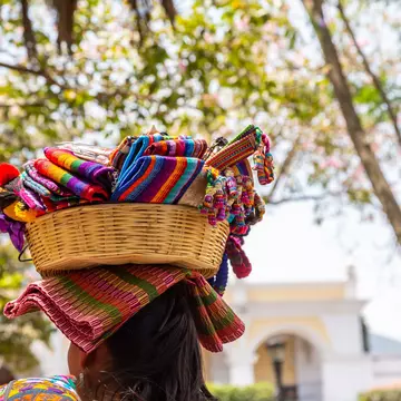 Woman with a basket of soevenirs on her head in the city of Antigua in Guatemala, Central America, License Type: media, Download Time: 2025-10-28T15:52:42.000Z, User: katelyn.perry_lonelyplanet, Editorial: false, purchase_order: 65050 - Digital Destinations and Articles, job: wip, client: wip, other: Katelyn Perry