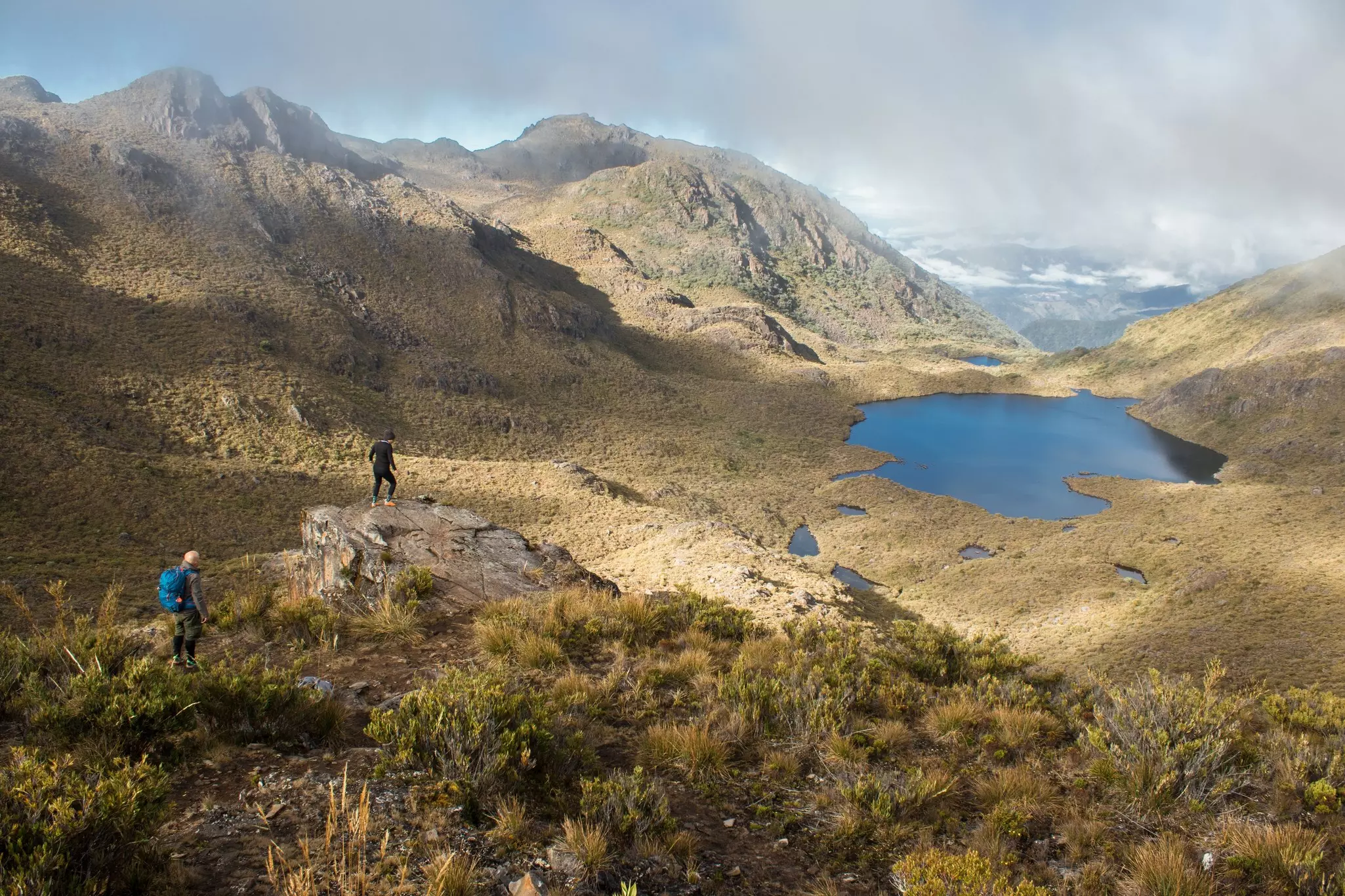 Hikers looking out over the rugged high-altitude grassland of Cerro Chirripó, Costa Rica's highest mountain.